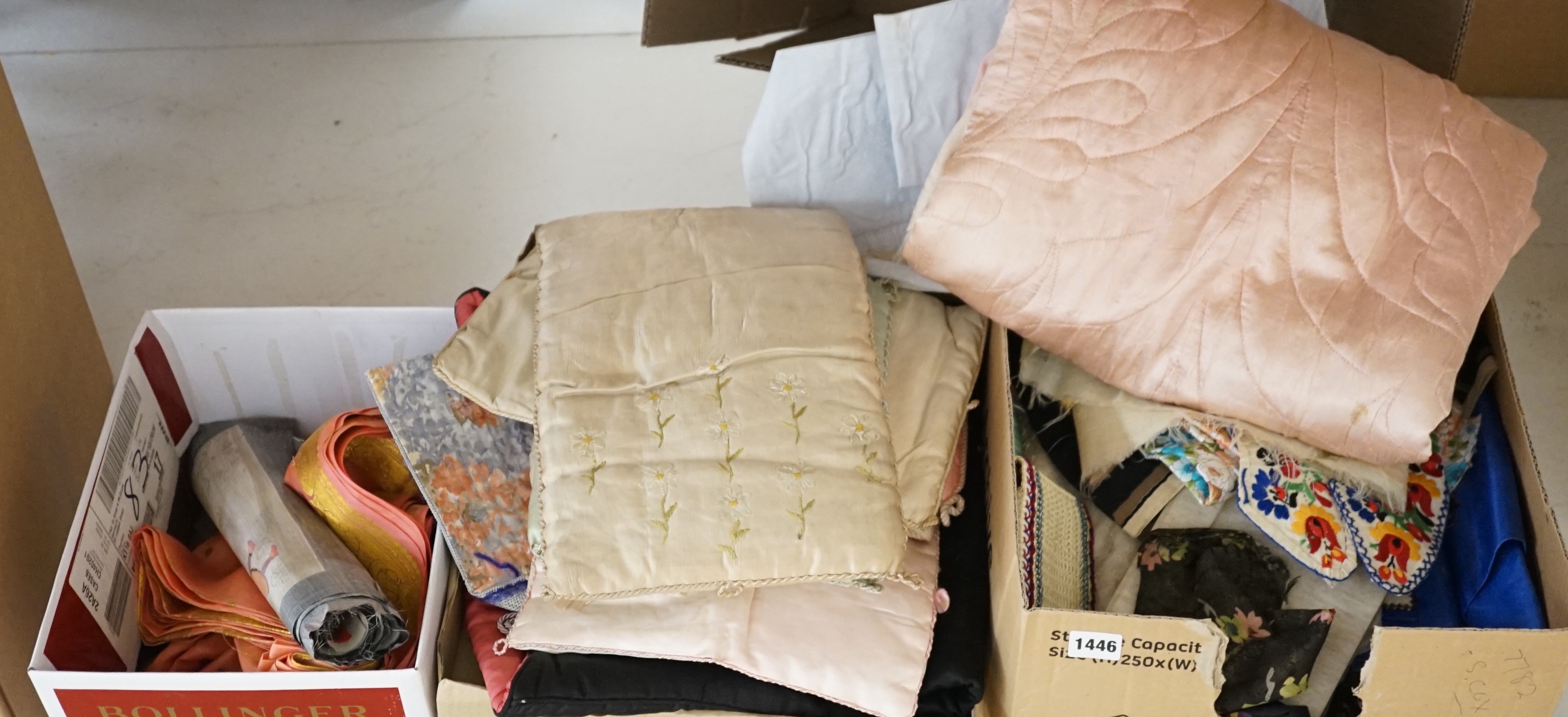 A large collection of mixed European textiles including ribbon worked pyjama cases, Indian painted textiles, a sample book of braidings etc
